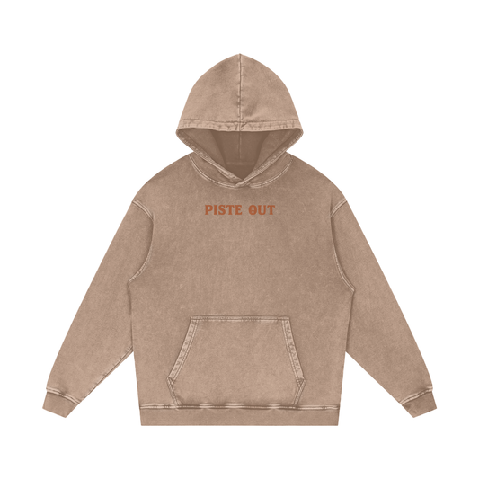 Front view of sand Colorado Cowboy hoodie with orange “PISTE OUT” chest print on faded vintage fabric.