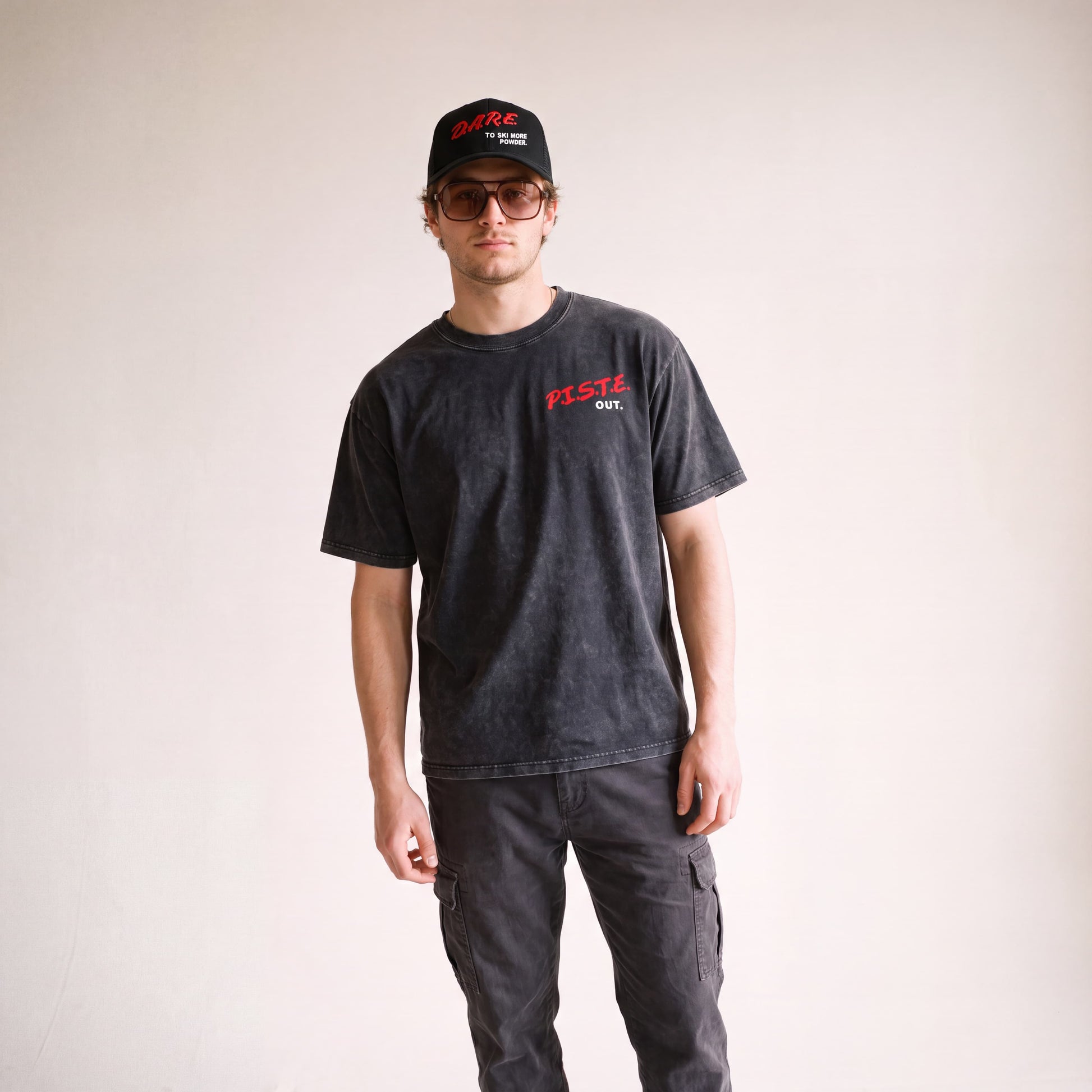 Male model standing and facing towards the camera, wearing the DARE short sleeve tee.