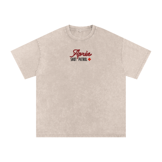 Front view of the Certified Après Professional tee in Apricot featuring a small Après Shot Patrol graphic on the chest.