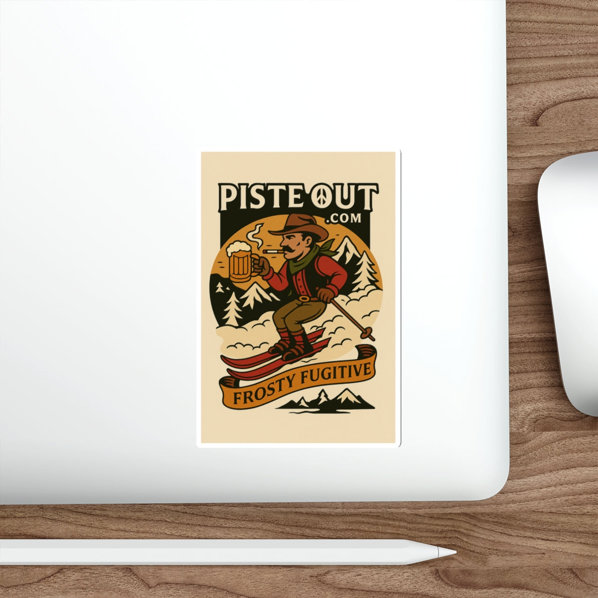 Frosty Fugitive sticker on a white laptop on a wooden desk