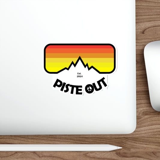 Sticker applied to white laptop, showing colorful Piste Out goggle logo with bold mountain