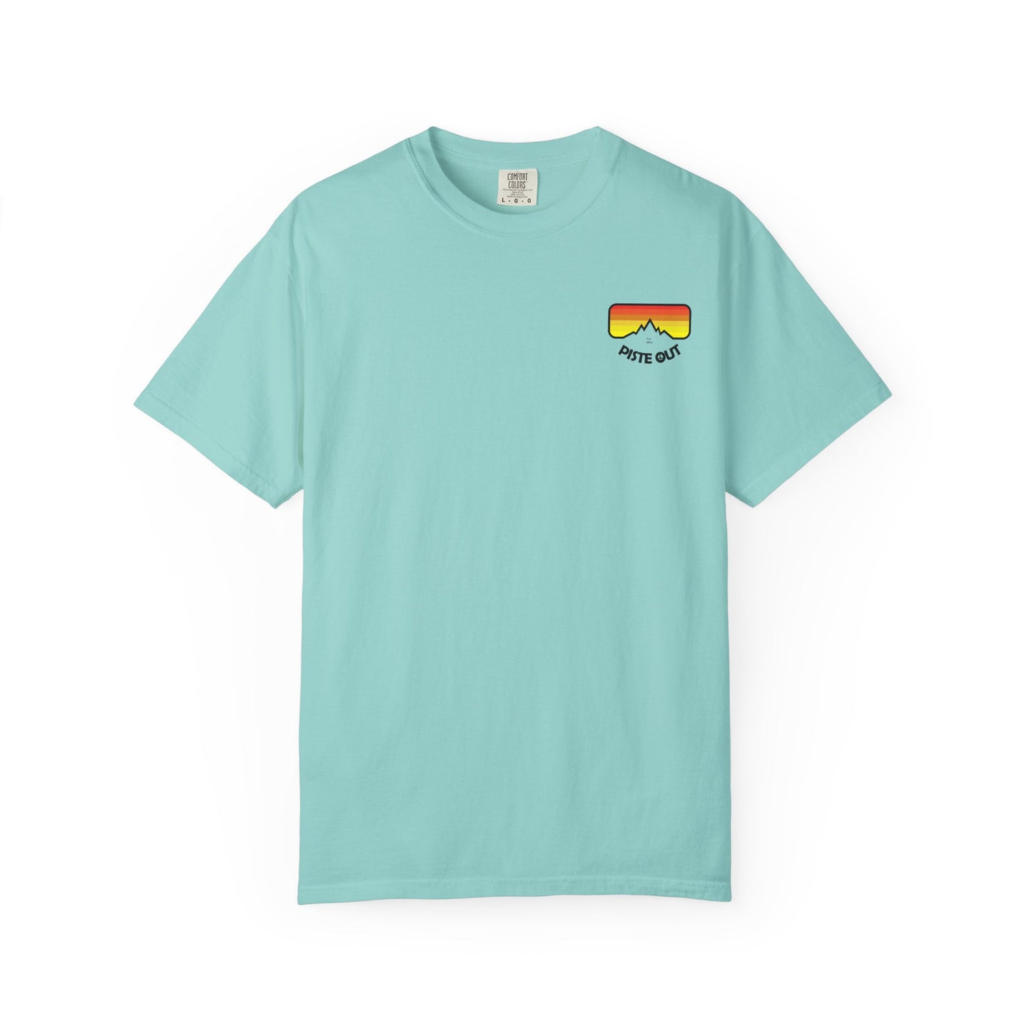 Front of coral blue tee featuring retro ski goggle chest logo with red-orange-yellow gradient and “PISTE OUT” text