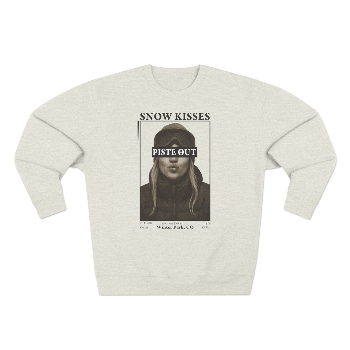 Front view of oatmeal Snow Kisses crewneck sweatshirt with vintage ski graphic and Piste Out logo.