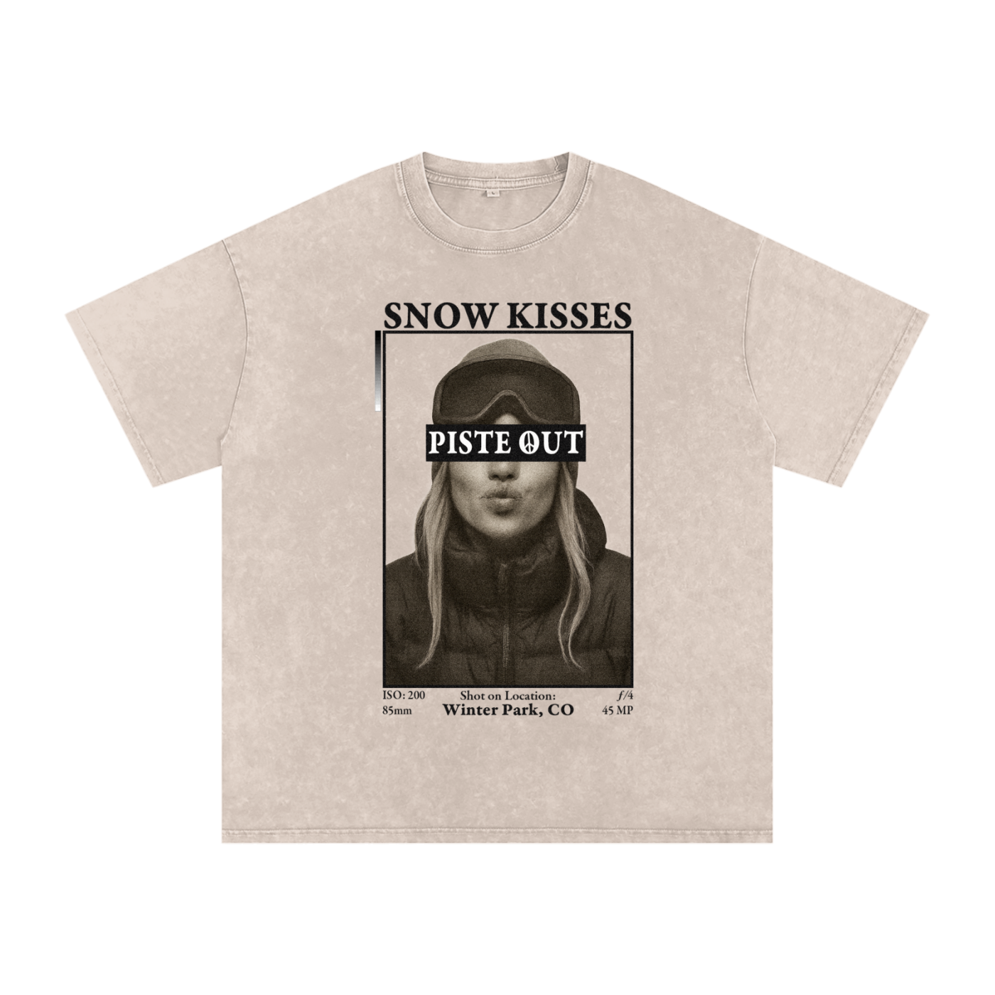 Front view of Apricot vintage-washed Snow Kisses tee featuring ski town crush graphic with Piste Out logo across goggles.