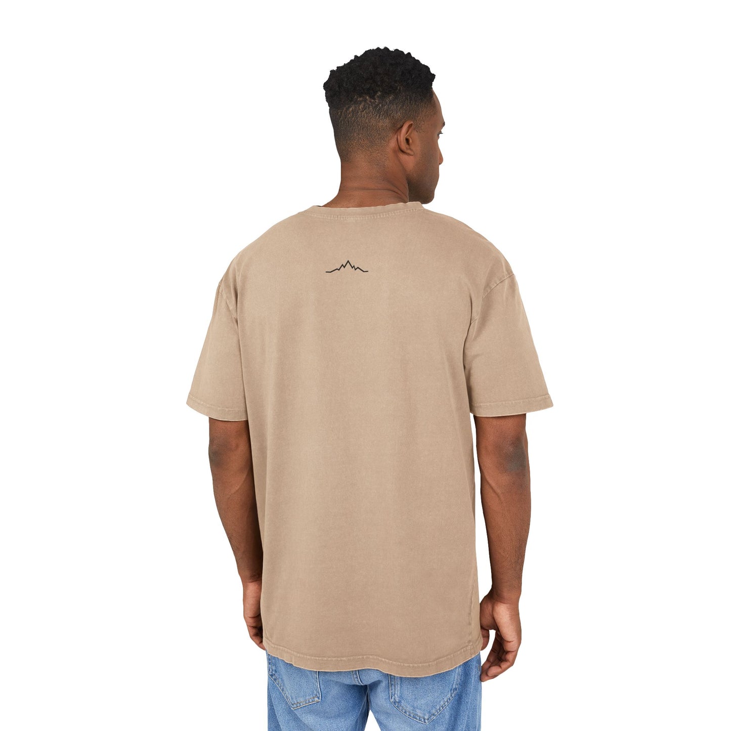 Model in beige tee, showing back mountain lines logo centered under collar