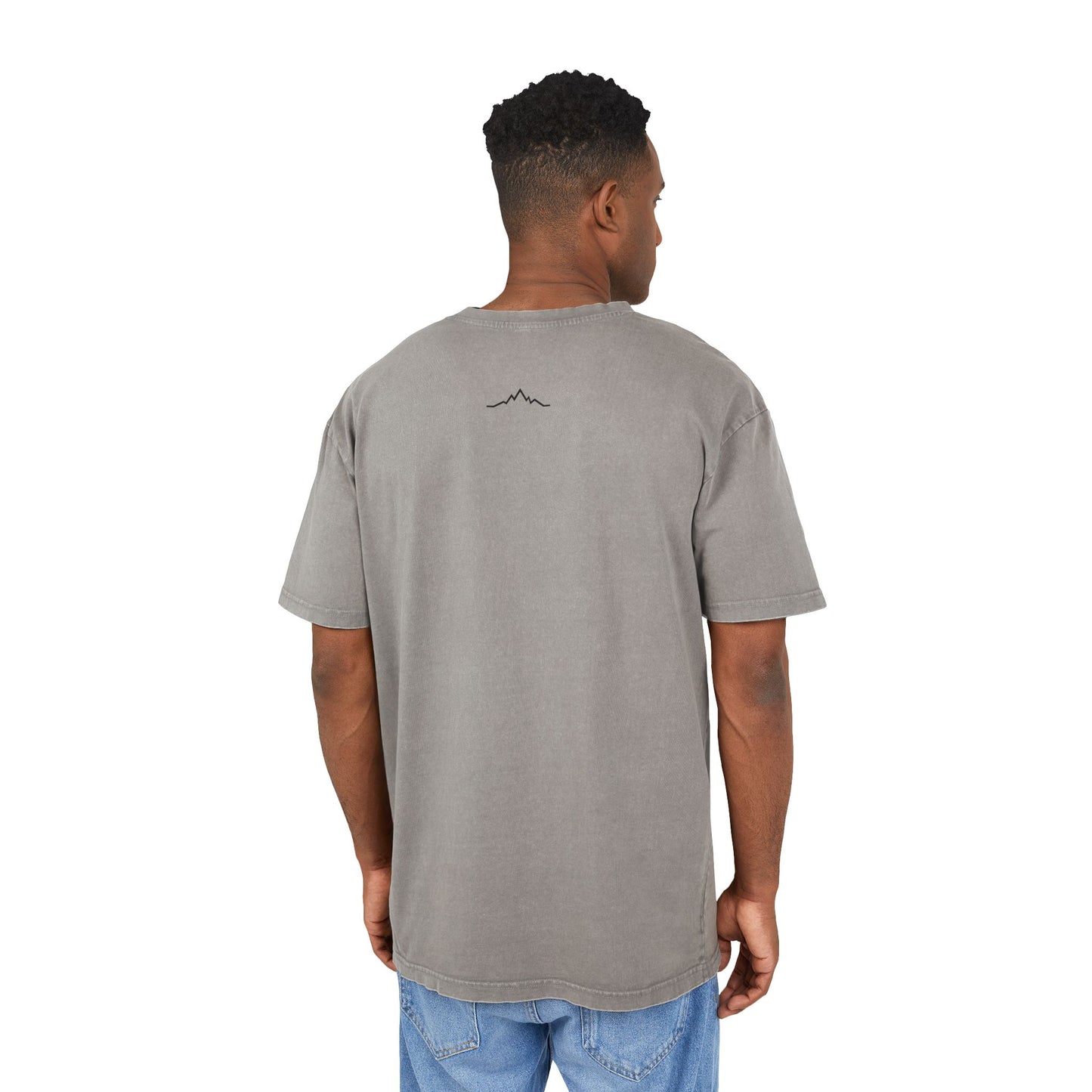 Model in grey tee, showing back mountain lines logo centered under collar
