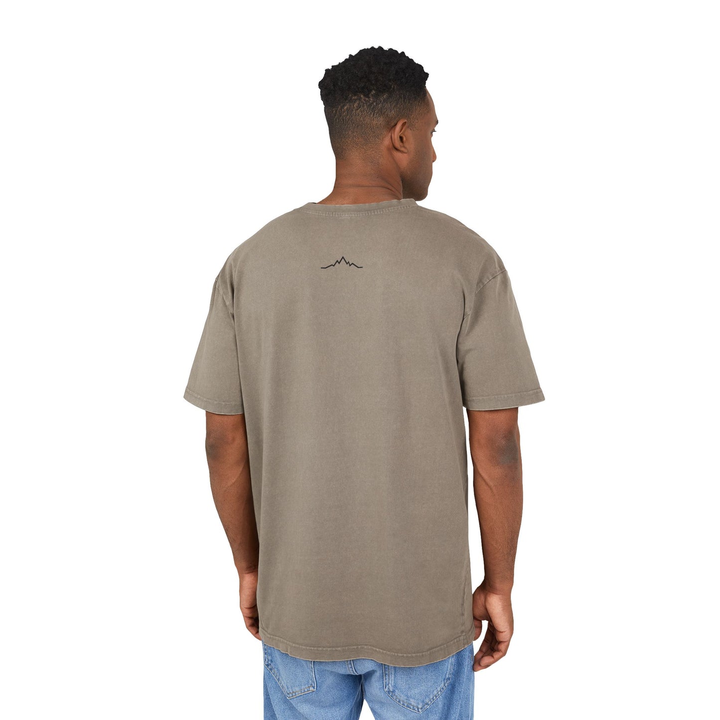 Model in faded taupe tee, showing back mountain lines logo centered under collar