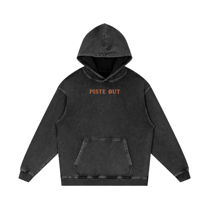 Front view of faded black diamond Colorado Cowboy hoodie with rustic orange “PISTE OUT” chest print.