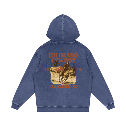 Back view of blue square Colorado Cowboy hoodie with sepia-toned cowboy riding horse and “Leadville, CO 1949” text.