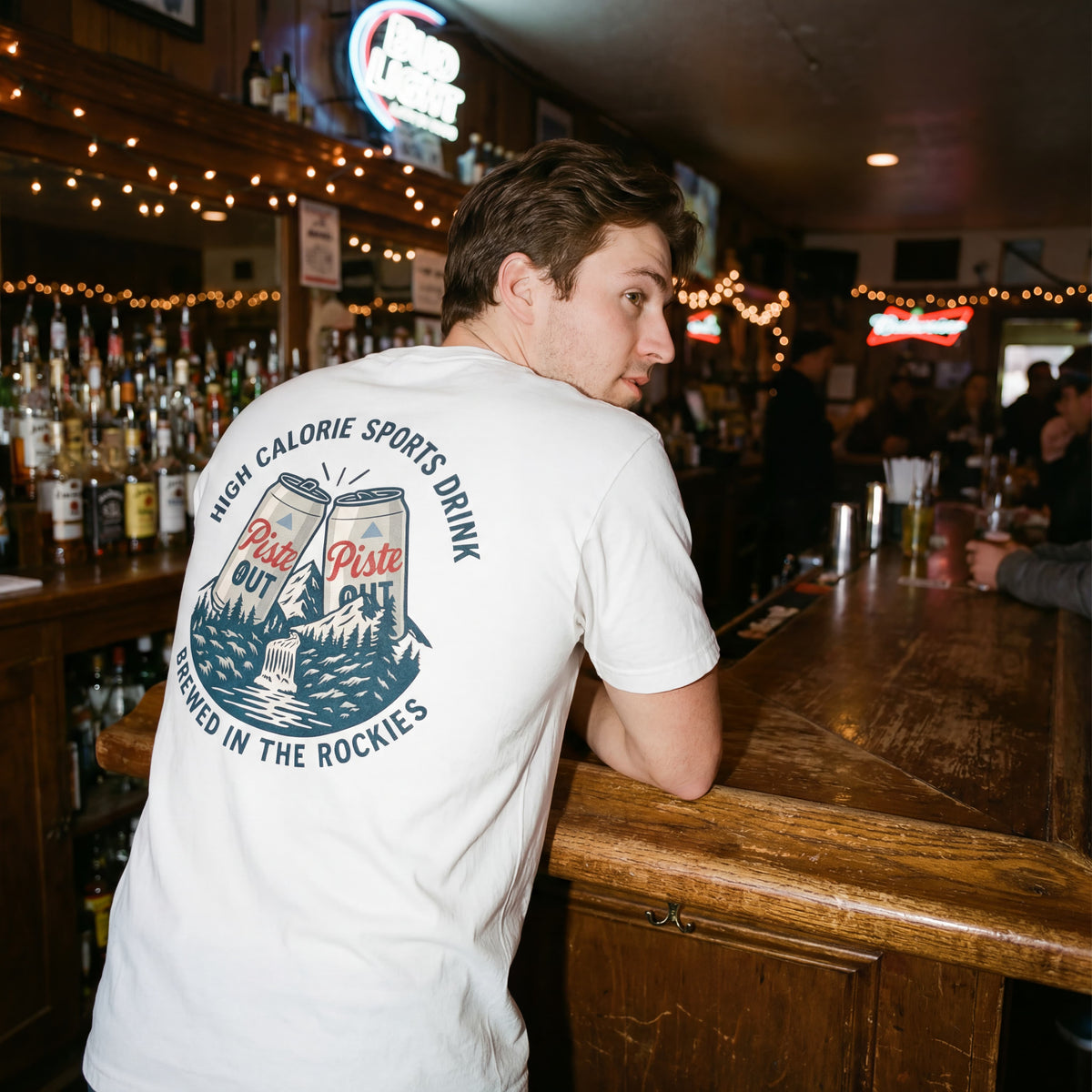 Male model wearing the High Calorie Sports Drink in Snow in a bar. 