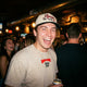 Model wearing Skiing Kills Tee in Tan in a crowded bar 