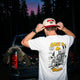 Male model wearing the Chill to the Bone tee in Snow and Skiing Kills Hat outside at dusk. 