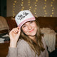Model wearing pink variant of the ski ya later trucker hat