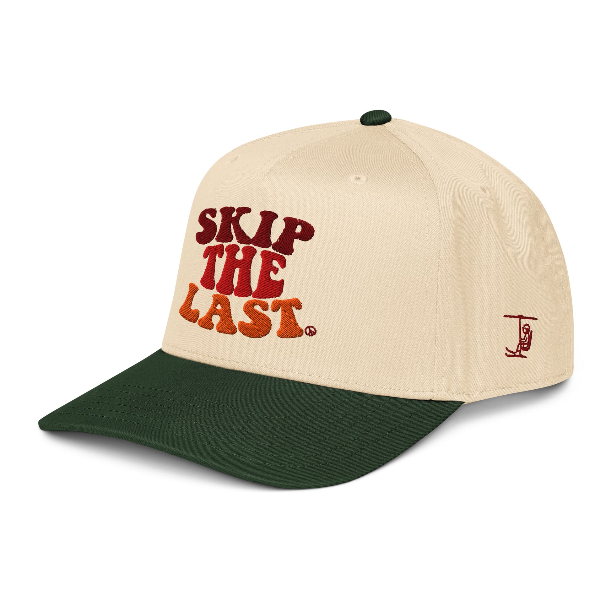 Angled view of the Skip the Last hat in Green Circle, showing the side skier embroidery, cream crown, forest green brim, and vintage ski lettering.