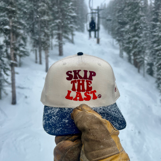 Skip the Last Hat in Blue Square outside in the snow. 