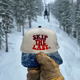 Skip the Last Hat in Blue Square outside in the snow. 