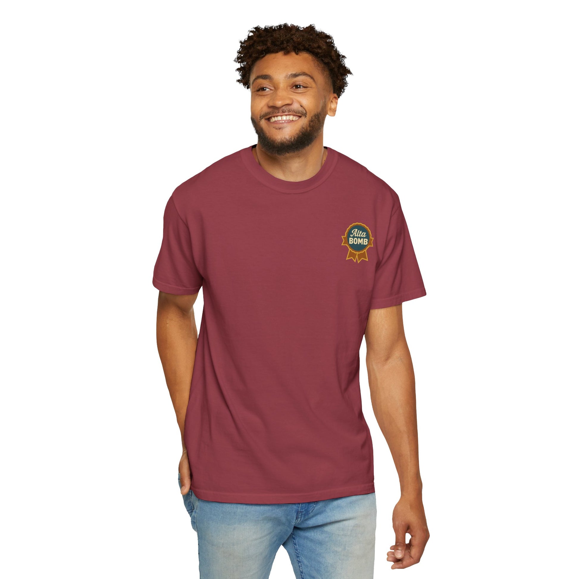 Model wearing maroon Alta Bomb t-shirt with chest ribbon badge design.