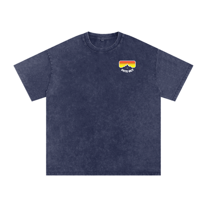 Front view of blue square American Gaper tee with small Piste Out goggle logo on the left chest.