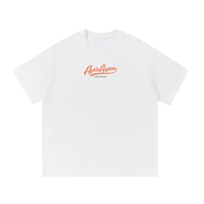 Snow white Après Aspen ski tee front view with coral Après Aspen logo and green Colorado text.
