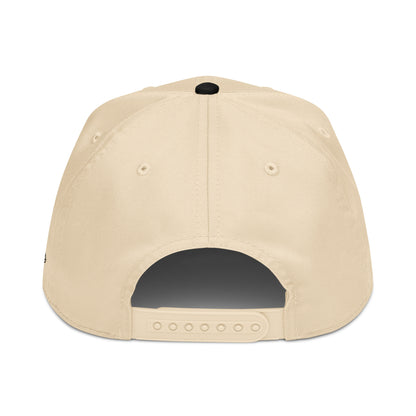 Back view of the cream and black Après Shot Patrol hat showing the adjustable snapback closure.