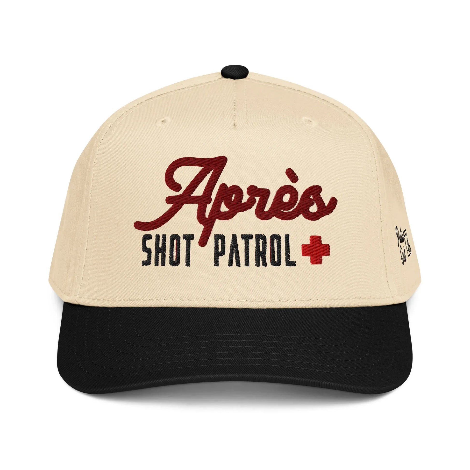 Front view of the cream and black Après Shot Patrol hat showing the main embroidery on the front