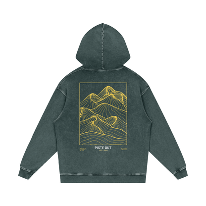 Back view of Green Circle Backcountry Veins hoodie showing gold topographic mountain line artwork and “Piste Out Est. 2024” text.