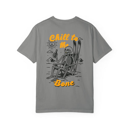 Back of grey tee featuring laid-back skeleton with skis, beer, and bold “Chill to the Bone” graphic