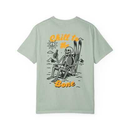 Back of sage green tee with bold Chill to the Bone graphic featuring skeleton in ski chair