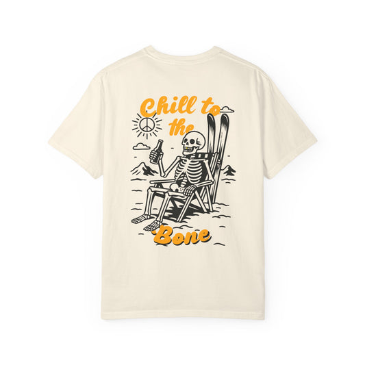 Back of ivory tee featuring laid-back skeleton with skis, beer, and bold “Chill to the Bone” graphic