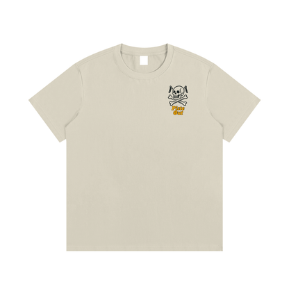 Front view of khaki Chill to the Bone tee with skull and ski pole emblem and orange Piste Out logo text.