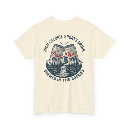 Back view of High Calorie Sports Drink tee in natural oatmeal color featuring two Piste Out cans clinking, mountain scene, and “High Calorie Sports Drink / Brewed in the Rockies” text.