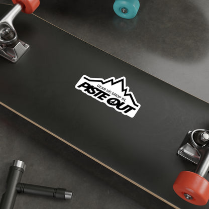 Sticker applied to skateboard deck, displaying iconic black Piste Out mountain design and peace-themed logo