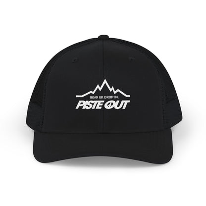 Front view of black trucker hat with white Piste Out mountain logo and slogan “Gear Up. Drop In.” embroidered on front