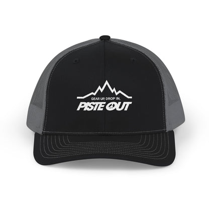 Front view of black and gray trucker hat with white Piste Out mountain logo and slogan embroidered on front