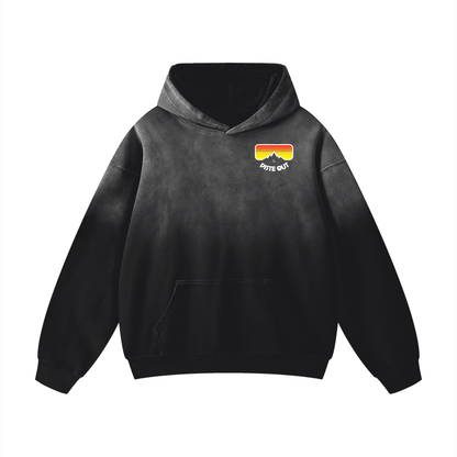 Front view of Black Diamond Piste Manifesto Hoodie with retro goggle chest logo and subtle faded texture.