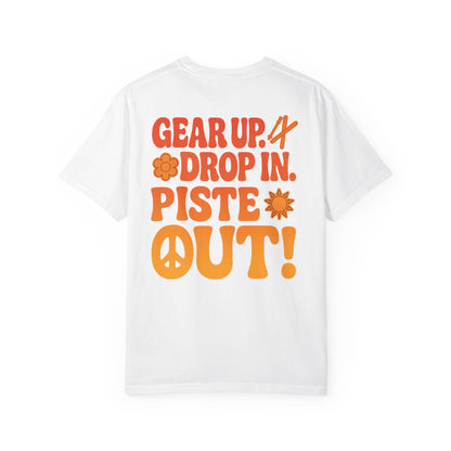 Back of white tee with large retro orange “Gear Up. Drop In. Piste Out!” slogan print
