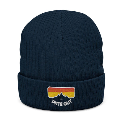 Front of navy blue ribbed beanie with embroidered retro goggle logo patch