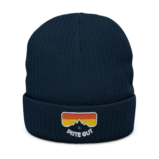 Front of navy blue ribbed beanie with embroidered retro goggle logo patch