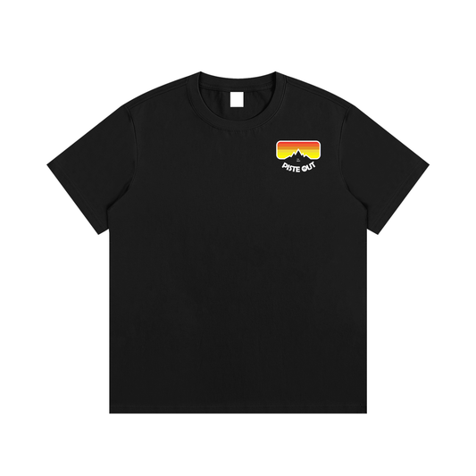 Front view of black Piste Out logo tee with small left-chest goggle logo in red, orange and yellow gradient.