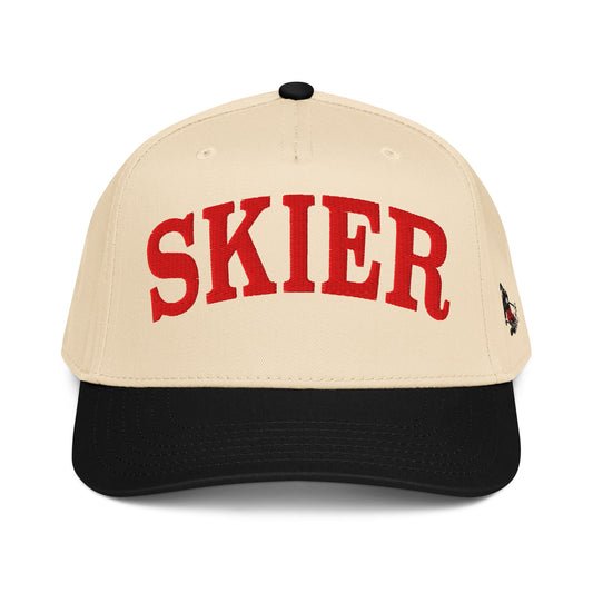 Product mockupSkier Cap in Black Diamond with red arched embroidery and vintage skier side panel graphic, side view