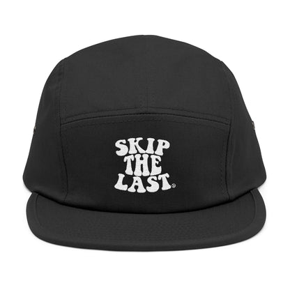 Front view of black Skip the Last 5-panel ski superstition hat with white embroidered text.