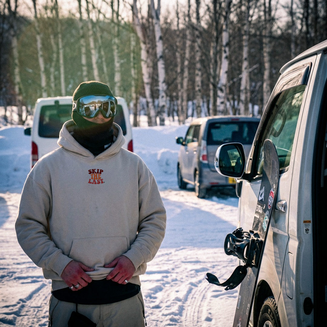 Ski in parking lot wear Piste Out Skip the Last Hoodie in Snow, front view with chest logo