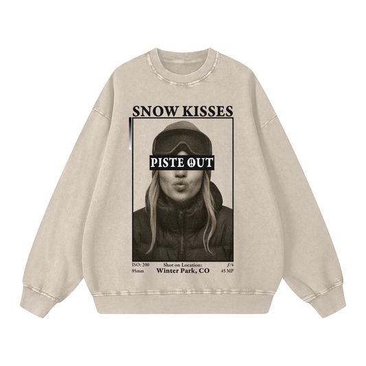 Front view of light apricot Snow Kisses vintage crewneck featuring ski town crush graphic and Piste Out logo across goggles.