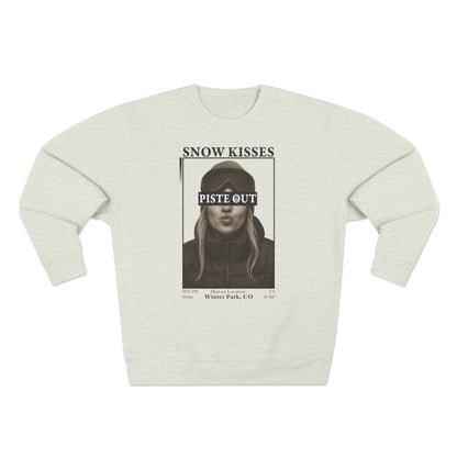 Front view of oatmeal Snow Kisses crewneck sweatshirt with vintage ski graphic and Piste Out logo.