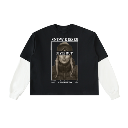 Front view of the Snow Kisses Layered Long Sleeve in black with white sleeves, featuring the vintage photo print and bold “SNOW KISSES” and “PISTE OUT” text.