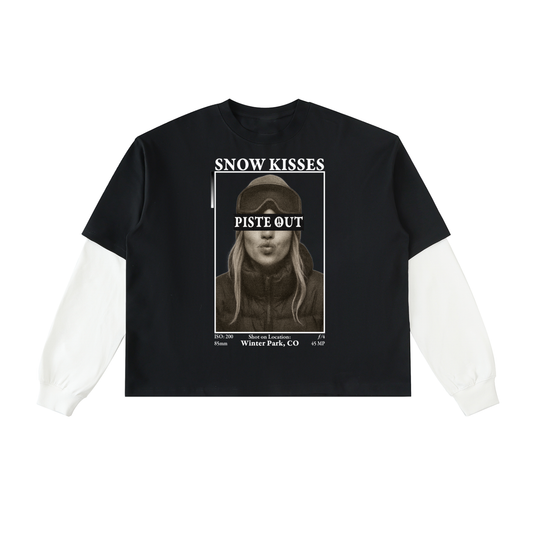 Front view of the Snow Kisses Layered Long Sleeve in black with white sleeves, featuring the vintage photo print and bold “SNOW KISSES” and “PISTE OUT” text.