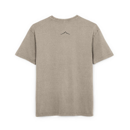 Back of faded taupe tee showing minimalist mountain line logo under collar