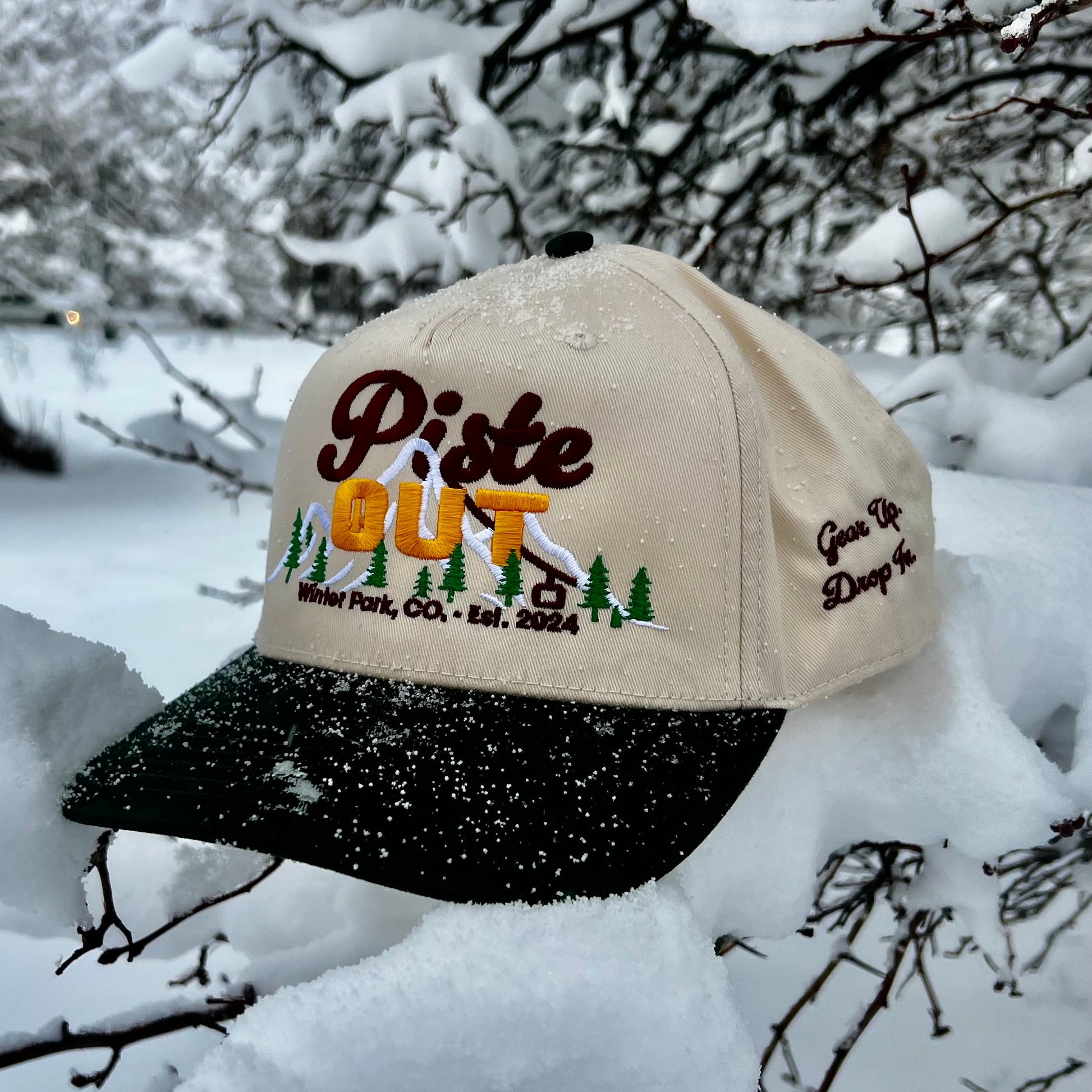 Green Circle Sunset Peaks snapback cap with cream crown and dark green brim photographed outdoors.