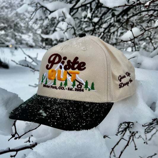 Green Circle Sunset Peaks snapback cap with cream crown and dark green brim photographed outdoors.
